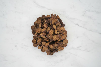 Pile of brown dog treats on a white background