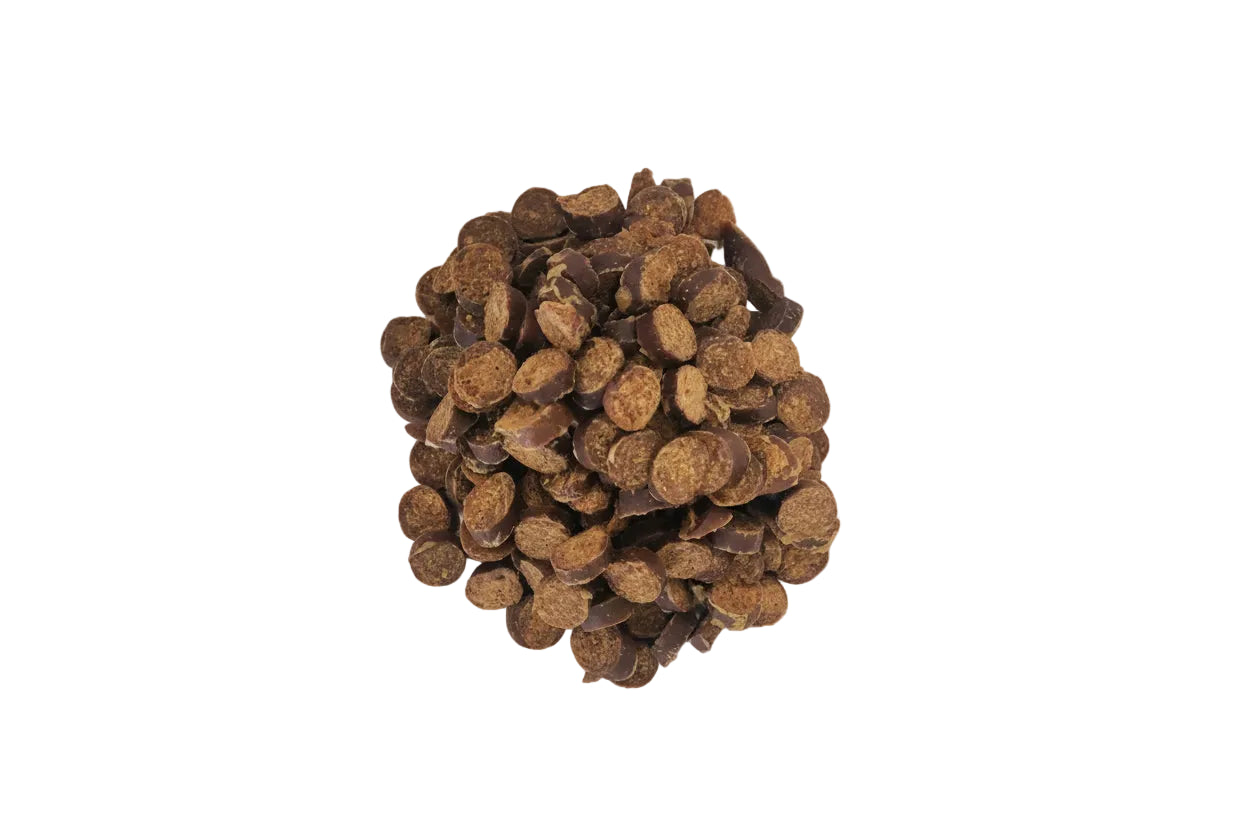 Pile of brown dog treats on a white background