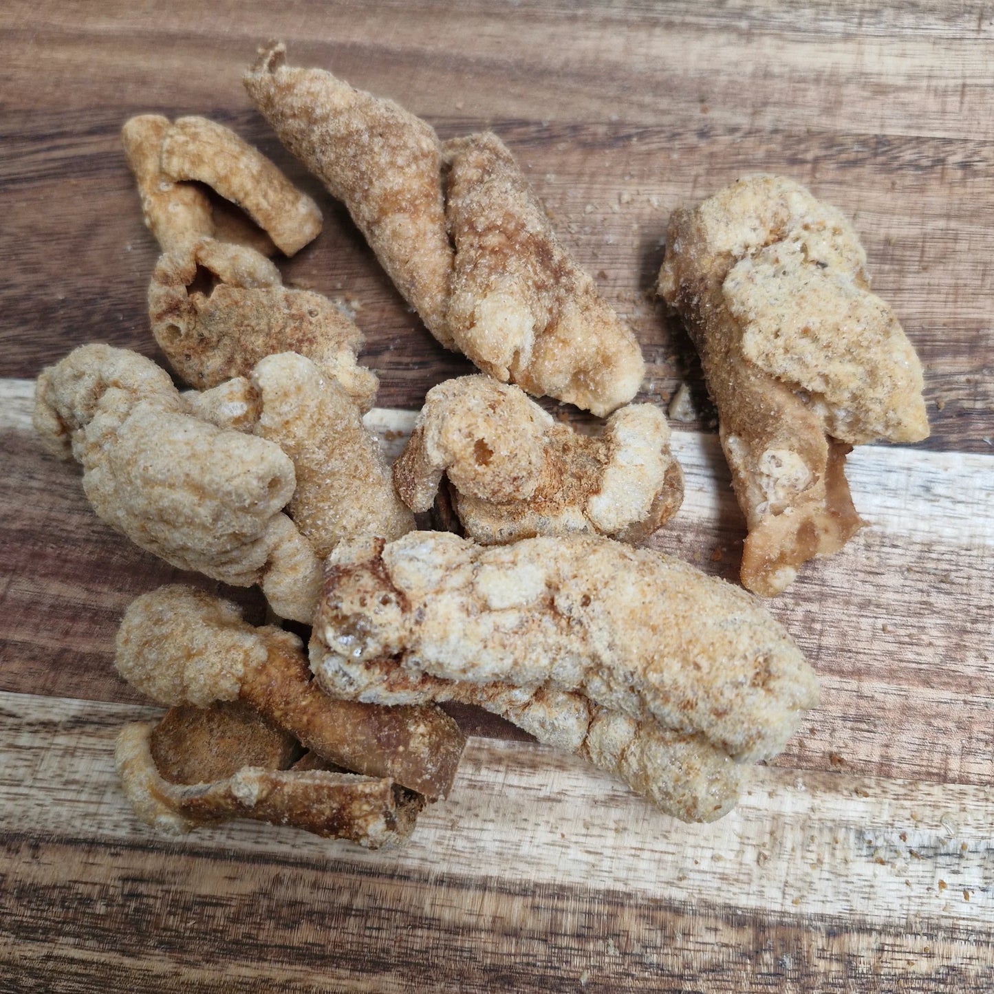 pork scratchings for dogs on a wooden board