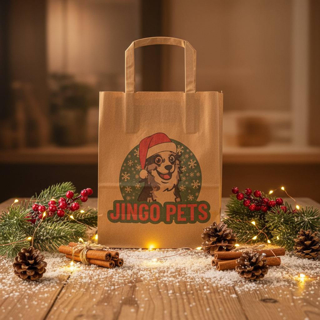 Brown paper bag with 'Jingo Pets' logo on a wooden table with Christmas decorations.