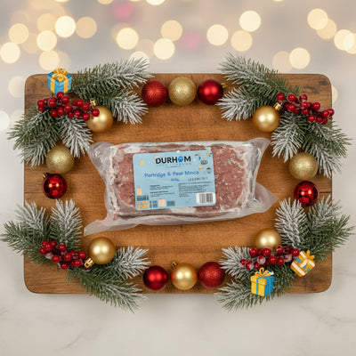 Packaged partridge and pear mince with Durham label on a shelf.
