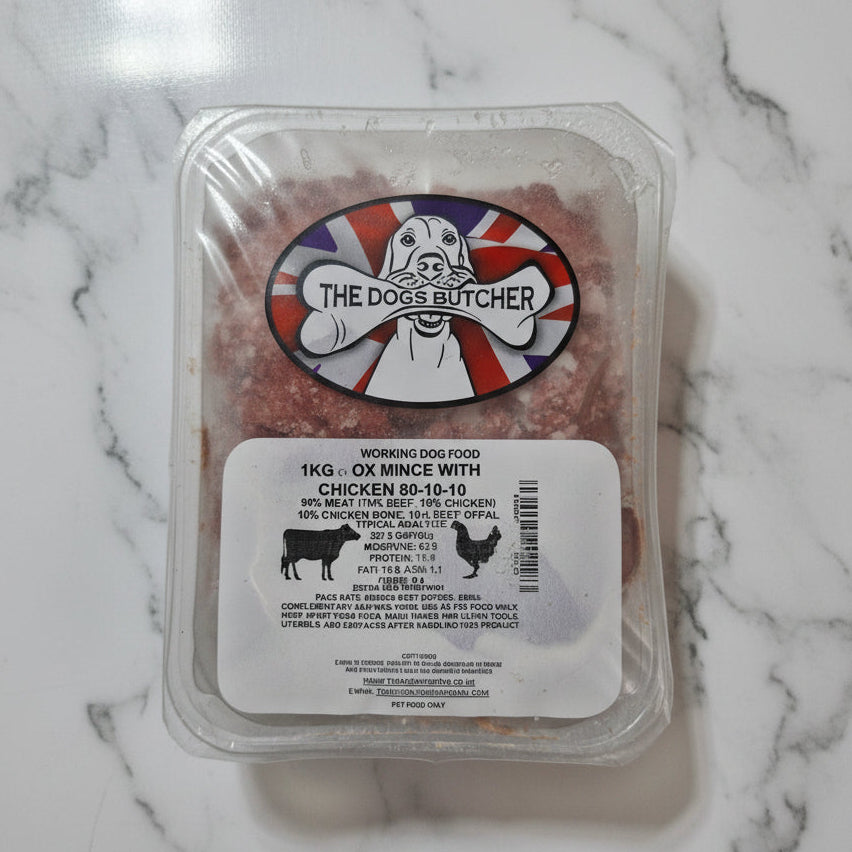 Packaged dog food with 'The Dog Butcher' label on a white surface