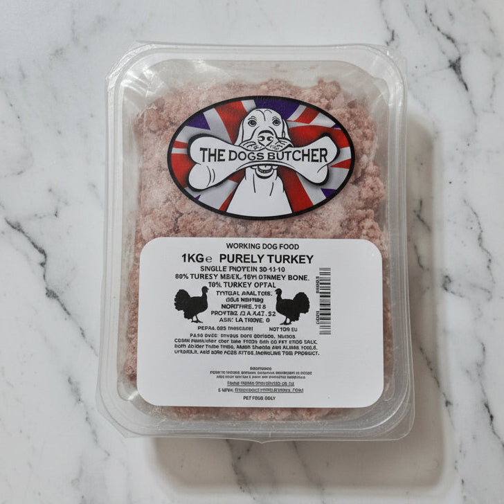 Packaged dog food with 'The Dogs Butcher' label on a white surface