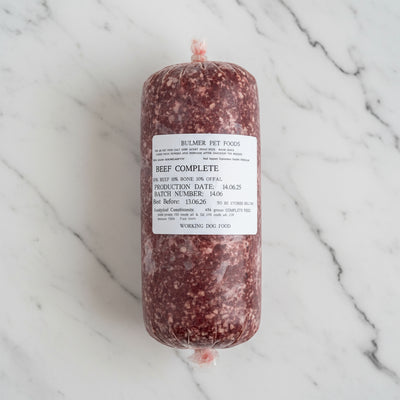Raw beef product with a label on a wooden surface