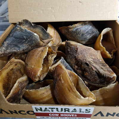 Box of cow hooves with a visible brand label on a neutral background