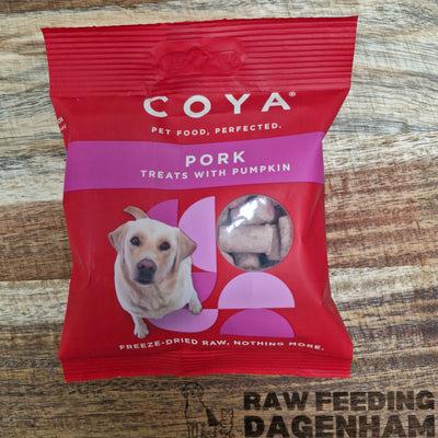 A package of COYA brand freeze-dried pork and pumpkin dog treats on a red background, with an image of a dog and the text 'Pork Treats with Pumpkin' displayed.