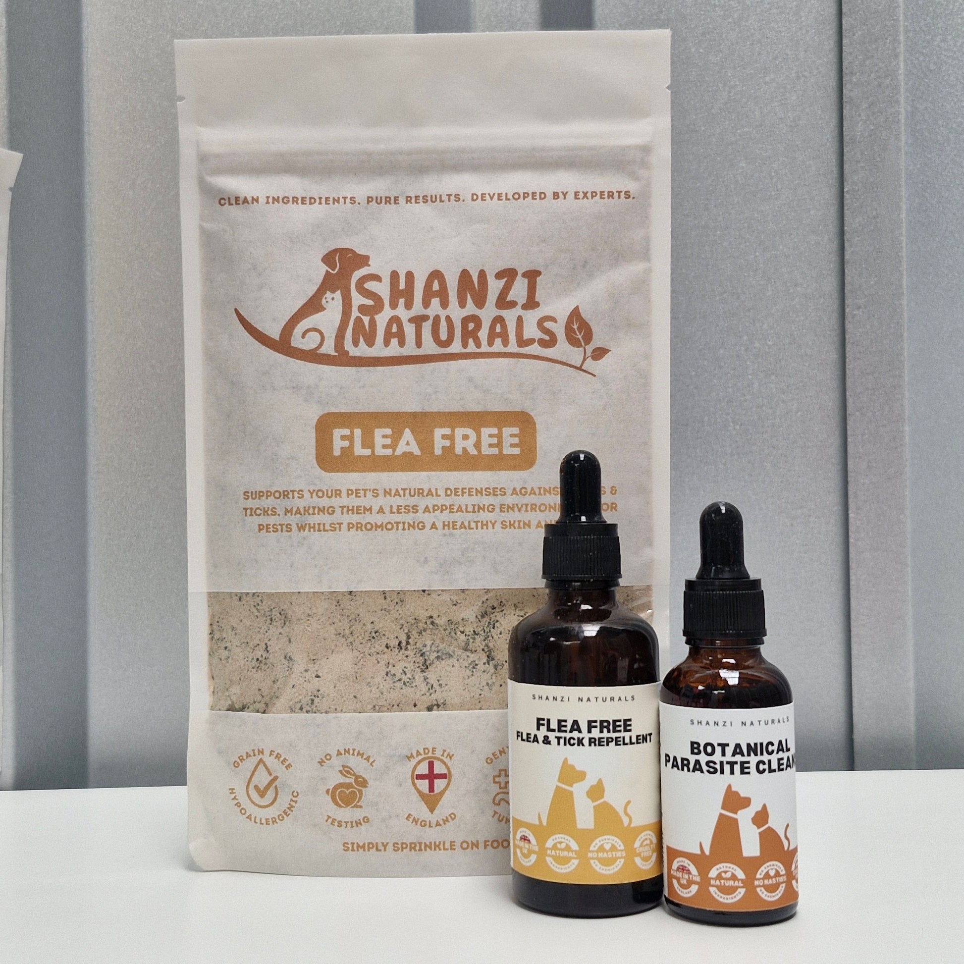 Shanzi Naturals flea-free product packaging with two dropper bottles on a gray background