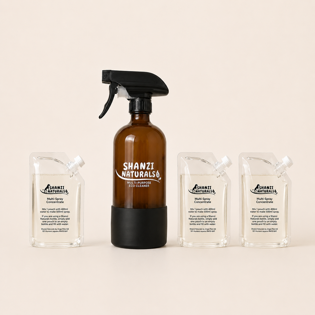 Shanzi Naturals eco cleaner set with a brown spray bottle and three clear containers on a beige background