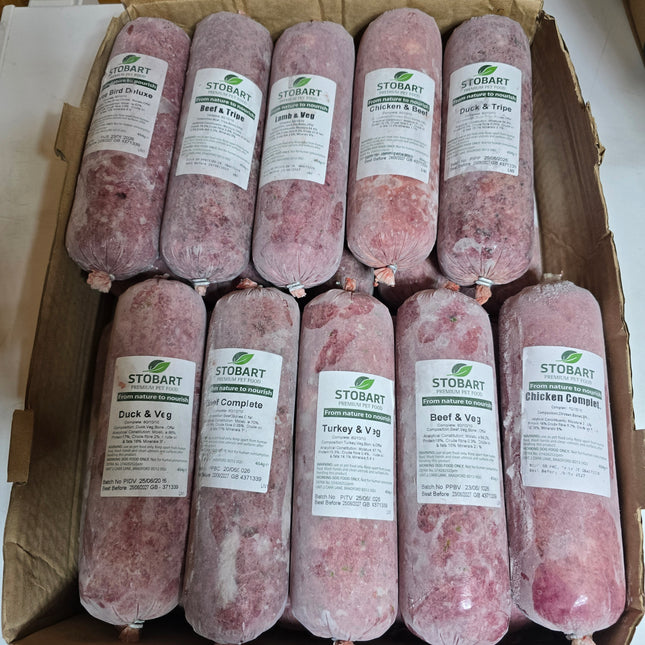 A cardboard box filled with twenty Stobart frozen sausages, arranged in two rows. The sausages are wrapped in clear plastic and have white labels showing different flavur options.