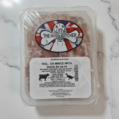 Packaged dog food with a label on a white surface